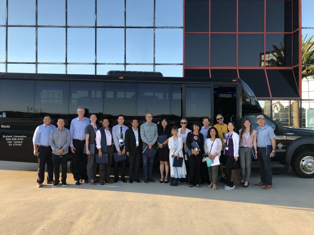 Study club group in front of a bus