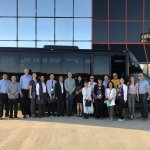Study club group in front of a bus
